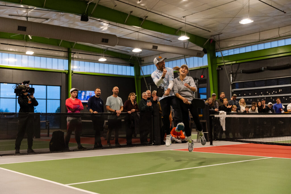 Teammates celebrating on pickleball court