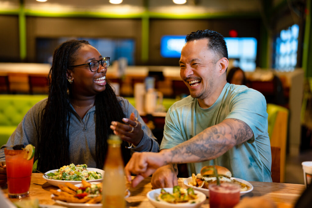 People eating drinking and laughing