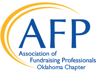 Logo for the Association of Fundraising Professionals Oklahoma Chapter, featuring the initials AFP in large blue letters with a yellow curved line arching around them, symbolizing a giveback mission benefiting vets and youth.