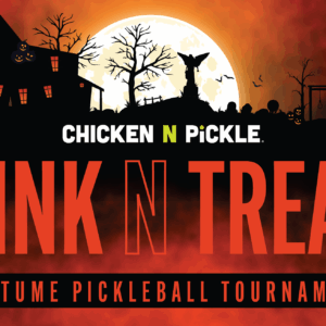 Halloween-themed graphic with haunted houses, bats, and pumpkins against an orange sky. Text reads: “Chicken N Pickle Dink N Treat Costume Pickleball Tournament.” A full moon is in the background.