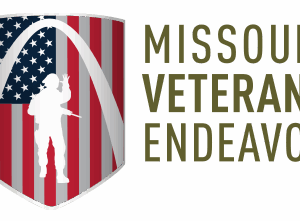 A shield with an American flag background, the Gateway Arch, and a white silhouette of a soldier symbolizes Giveback Benefiting Vets, next to the words Missouri Veterans Endeavor in large olive-green letters.