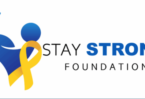 Logo for Stay Strong Foundation featuring a blue stylized figure flexing an arm, a yellow awareness ribbon, and the words “STAY STRONG FOUNDATION” in black and blue text.