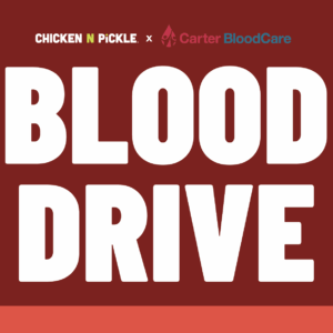 Red graphic with large white text reading BLOOD DRIVE. At the top, logos for Chicken N Pickle and Carter BloodCare are displayed, indicating a collaborative blood drive event.