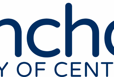 Logo for BronchoThon at the University of Central Oklahoma, featuring a yellow teardrop-shaped icon with a white center resembling a flame, highlighting its giveback mission benefiting vets and youth, next to the text BronchoThon and University of Central Oklahoma.
