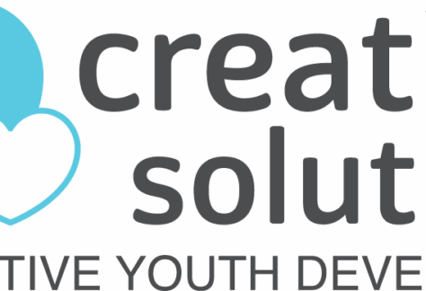 Logo with two overlapping hearts—one multicolored and one solid blue—beside the words creative solutions in gray, FOR POSITIVE YOUTH DEVELOPMENT below, and highlighting Giveback Benefiting Vets for Youth.