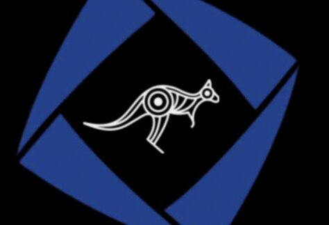 A white stylized kangaroo with tribal patterns is centered on a black background, surrounded by a blue, tilted square frame with open corners—symbolizing a giveback benefiting vets for youth.