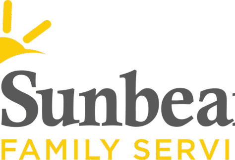 Logo for Sunbeam Family Services featuring a stylized yellow sun on the left and the words Sunbeam in large gray letters above FAMILY SERVICES in smaller yellow letters, representing their Giveback Benefiting Vets for Youth initiative.