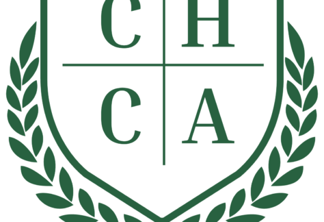 A green and white crest with the letters C, H, C, and A arranged in four quadrants, surrounded by a laurel wreath on each side, symbolizes a commitment to giveback benefiting vets for youth.
