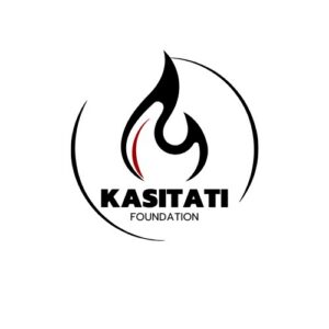 Logo for Kasitati Foundation featuring a stylized black flame with a red accent, encircled by two black curved lines. The design symbolizes giveback, benefiting vets and youth. KASITATI appears bold, with FOUNDATION below in smaller letters.