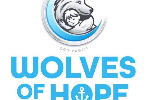 Logo for Wolves of Hope Special Needs Foundation featuring a stylized wolf embracing a child inside a blue crescent. Text below highlights the non-profit’s special needs and giveback focus, benefiting vets for youth, with an anchor symbol.