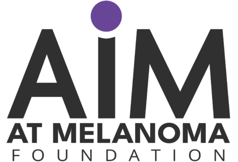 AIM at Melanoma Foundation logo with the word AIM in large black letters, a purple dot above the I, and AT MELANOMA FOUNDATION below—proudly supporting Giveback Benefiting Vets for Youth.