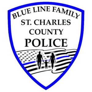A police badge with a blue outline reads Blue Line Family St. Charles County Police above an American flag with a blue stripe and silhouettes of two adults and a child holding hands, highlighting a Giveback Benefiting Vets for Youth.
