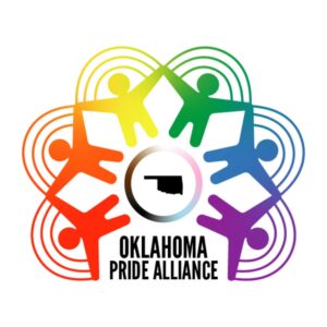 Logo for Oklahoma Pride Alliance featuring six rainbow-colored figures holding hands in a circle around an outline of Oklahoma state, with OKLAHOMA PRIDE ALLIANCE written below. Rainbow arcs connect the figures, symbolizing giveback benefiting vets and youth.