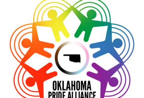 Logo for Oklahoma Pride Alliance featuring six rainbow-colored figures holding hands in a circle around an outline of Oklahoma state, with OKLAHOMA PRIDE ALLIANCE written below. Rainbow arcs connect the figures, symbolizing giveback benefiting vets and youth.