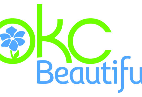 Logo with bright green letters OKC and a blue flower inside the O. The word Beautiful appears below in light blue, highlighting its Giveback mission benefiting Vets for Youth.