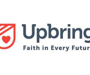 Upbring logo with a red shield featuring a heart on the left, and the words Upbring Faith in Every Future in gray text on the right, highlighting their Giveback Benefiting Vets for Youth initiative.