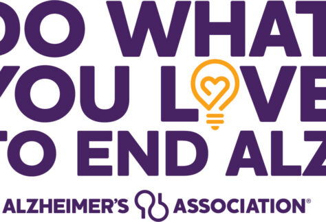 Purple text reads Do what you love to end ALZ. The O in love is a yellow light bulb with a heart inside. Alzheimers Association appears at the bottom with a key-shaped logo, Benefiting Vets for Youth through this meaningful giveback initiative.
