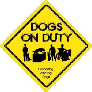 Yellow diamond-shaped sign with DOGS ON DUTY in bold black letters, silhouettes of dogs and handlers, including a wheelchair user, and text Supporting Working Dogs underneath. Perfect for your 10% Giveback Night Benefiting HEAL Center for the Arts at Chicken N Pickle.