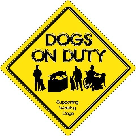 Yellow diamond-shaped sign with DOGS ON DUTY in bold black letters, silhouettes of dogs and handlers, including a wheelchair user, and text Supporting Working Dogs underneath. Perfect for your 10% Giveback Night Benefiting HEAL Center for the Arts at Chicken N Pickle.