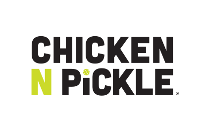 Chicken N Pickle logo with bold black text. The N is bright green, and the I in PICKLE is dotted with a small pickleball, referencing the companys food and pickleball theme. Background is light gray.