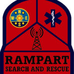 A red badge with Rampart Search and Rescue text, featuring a compass, a medical symbol, and a radio tower symbol above the text. Includes a 10% Giveback to Bodhi Battalion Giveback Event at Chicken N Pickle.