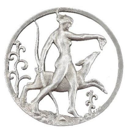 A silver medallion showing a nude woman holding a bow and leading a deer by the neck, with ornate floral designs framing the scene.