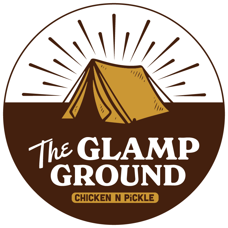 Logo with a yellow tent under sun rays, encircled by brown. Text reads, The Glamp Ground and Chicken N Pickle on a yellow banner at the bottom.