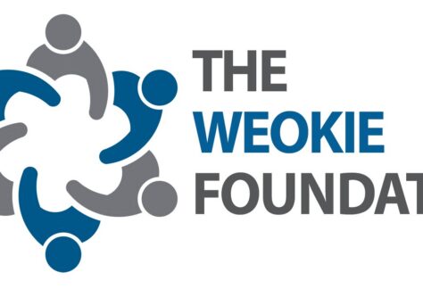 Logo for The WEOKIE Foundation featuring five abstract human figures in a circular formation next to the organizations name in blue and gray text on a white background.