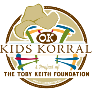 Kids Korral logo featuring a cowboy hat, drumsticks, and colorful stick figures, with text: A Project of The Toby Keith Foundation and the website www.tobykeithfoundation.org.