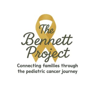 A gold ribbon with the words The Bennett Project and the tagline Connecting families through the pediatric cancer journey below it, in recognition of the 10% Giveback Night Benefiting The Arya Foundation at Chicken N Pickle.