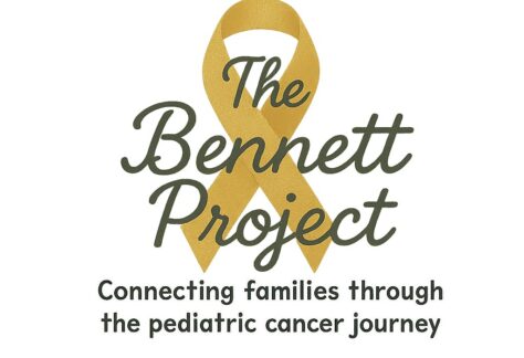 A gold ribbon with the words The Bennett Project and the tagline Connecting families through the pediatric cancer journey below it, in recognition of the 10% Giveback Night Benefiting The Arya Foundation at Chicken N Pickle.