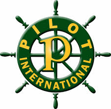 Logo for Pilot International featuring a large yellow letter P centered inside a green ships wheel with the words Pilot International encircling it in yellow text.